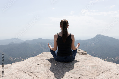 girl doing yoga on the mountain