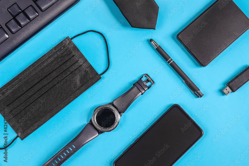 Watch, smartphone and mask on a light blue background. Watch, smartphone and mask on a light blue background.
