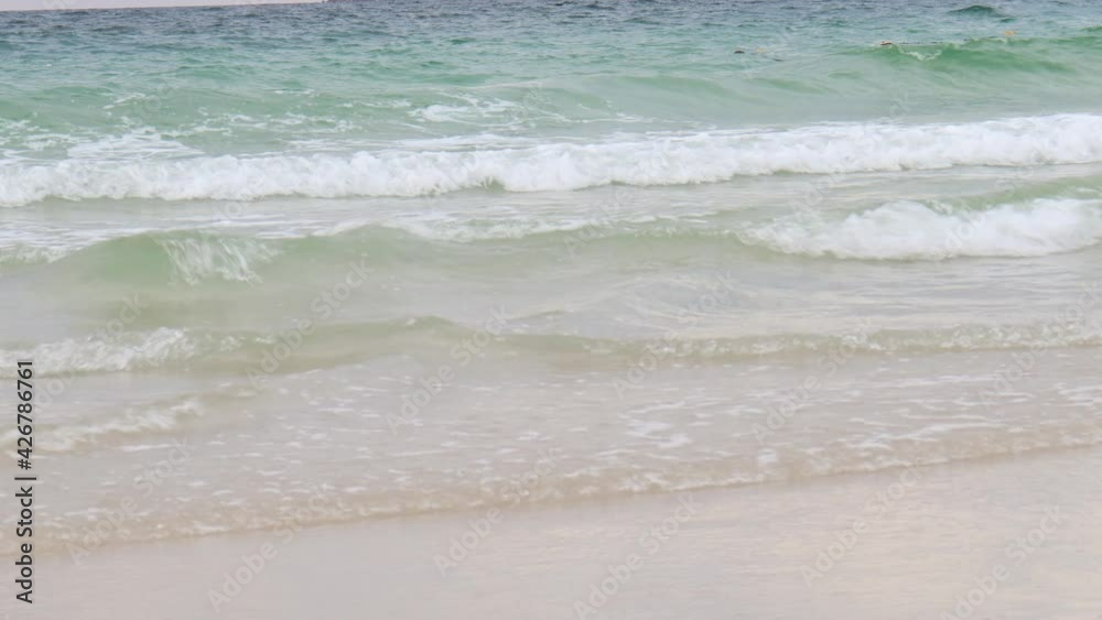 Ocean waves crashing on white sand beach, beautiful natural scene of tropical summer sea beach Ocean waves crashing on white sand beach, beautiful natural scene of tropical summer sea beach