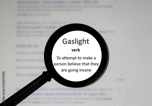 Selective focus on word Gaslight, word in a dictionary. Close up of an English dictionary page with the word Gaslight photo