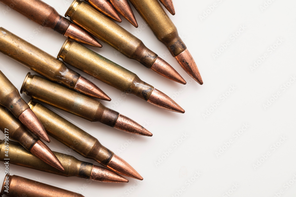 A group of bullet ammunition shells on a white background A group of bullet ammunition shells on a white background