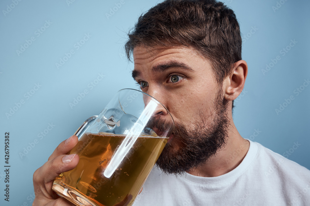 Cheerful drunk man beer mug diet food fun blue background Cheerful drunk man beer mug diet food fun blue background