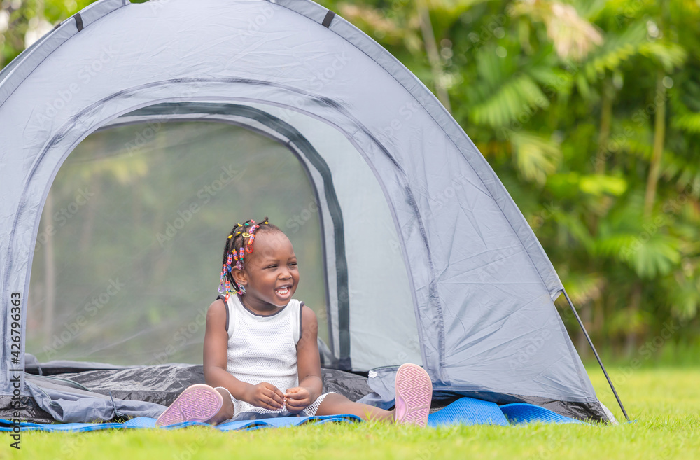 Cheerful african american little girl playing in the park, Happiness family concepts Cheerful african american little girl playing in the park, Happiness family concepts