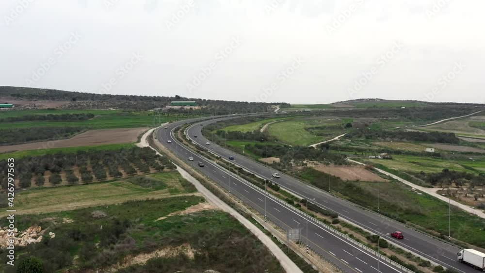 Traffic on a Countryside Highway road surrounded by Agricultural fields, Aerial view.
Traffic on a Countryside Highway road surrounded by Agricultural fields, Aerial view.