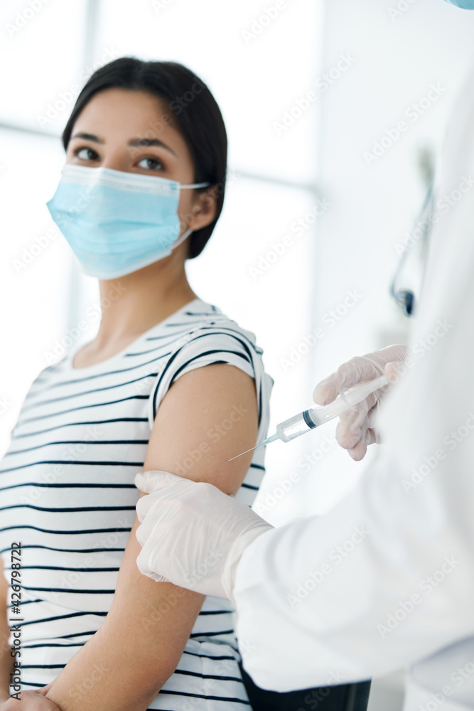 male doctor in white coat makes about turned on female patient vaccination