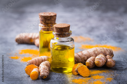 Turmeric essential oil, orange root and powder, beauty and spa