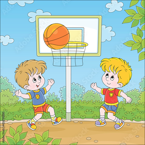 Cheerful little kids playing basketball with a big orange ball on a sports ground in a green park on summer vacations, vector cartoon illustration