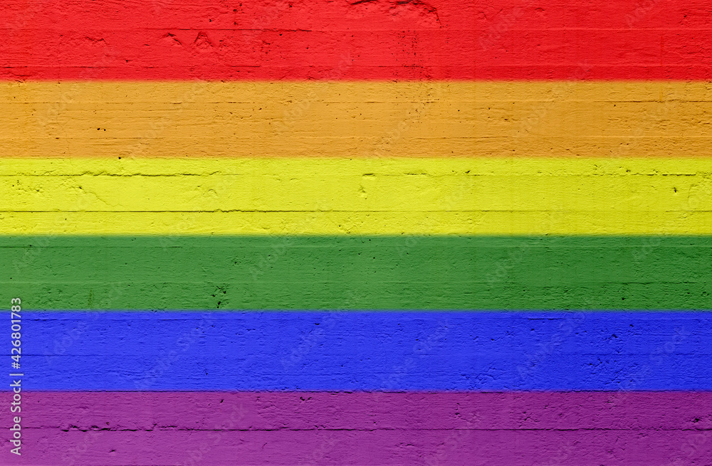 Rainbow colored LGBT pride flag painted on a concrete wall. High resolution full frame textured background of a plastered and colorful concrete wall. Copy space. Rainbow colored LGBT pride flag painted on a concrete wall. High resolution full frame textured background of a plastered and colorful concrete wall. Copy space.