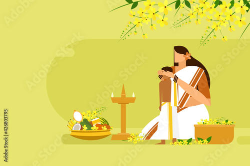 Mother blindfolds her son in front of auspicious items. A traditional ritual during the 'Vishu' festival in Kerala