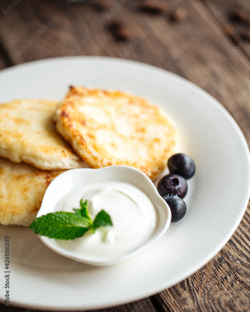 Russian breakfast cottage cheese pancakes with sour cream