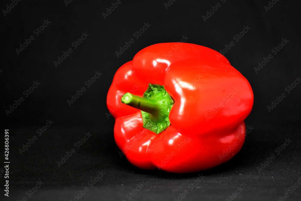 Close-up red bell pepper on black background,food photo Close-up red bell pepper on black background,food photo