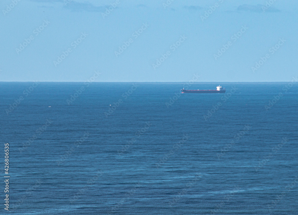 Cargo Ship Leaving Port on Calm Sea Cargo Ship Leaving Port on Calm Sea
