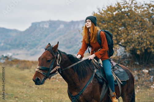cheerful woman Tourist riding a horse nature mountains joy