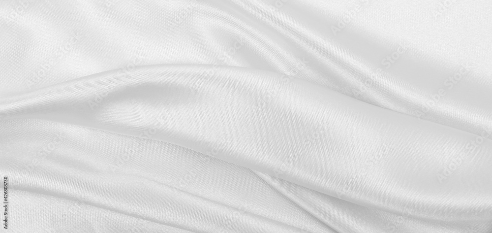 Naklejka premium Smooth elegant white silk or satin luxury cloth texture as wedding background. Luxurious background design
