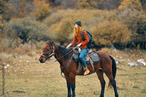 woman hiker in the mountains riding a horse travel lifestyle © SHOTPRIME STUDIO