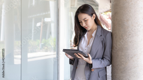Young Asian business women communicate with business partners through tablets, Talking with wireless technology, Business data analysis using a tablet, Digital document. Free Download Young Asian business women communicate with business partners through tablets, Talking with wireless technology, Business data analysis using a tablet, Digital document. - GFXLoad