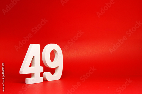 Forty Nine ( 49 ) white number wooden Isolated Red Background with Copy Space - New promotion 49% Percentage  Business finance Concept  photo