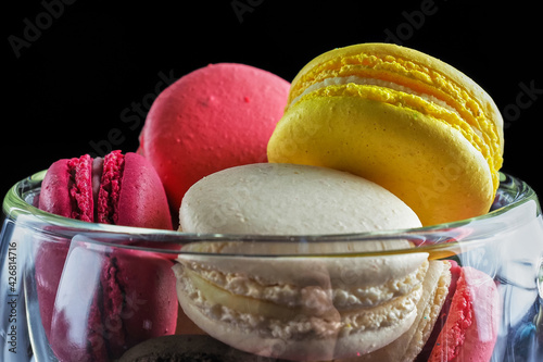 Sweet Macaron of different colors on an darke background photo