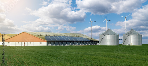 Modern dairy farm using renewable energy, solar panels and wind turbines	
