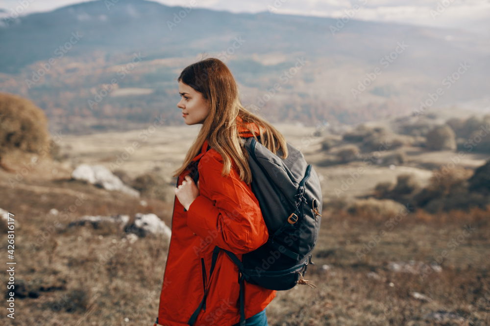 woman in a jacket travel in the mountains outdoors fresh air model