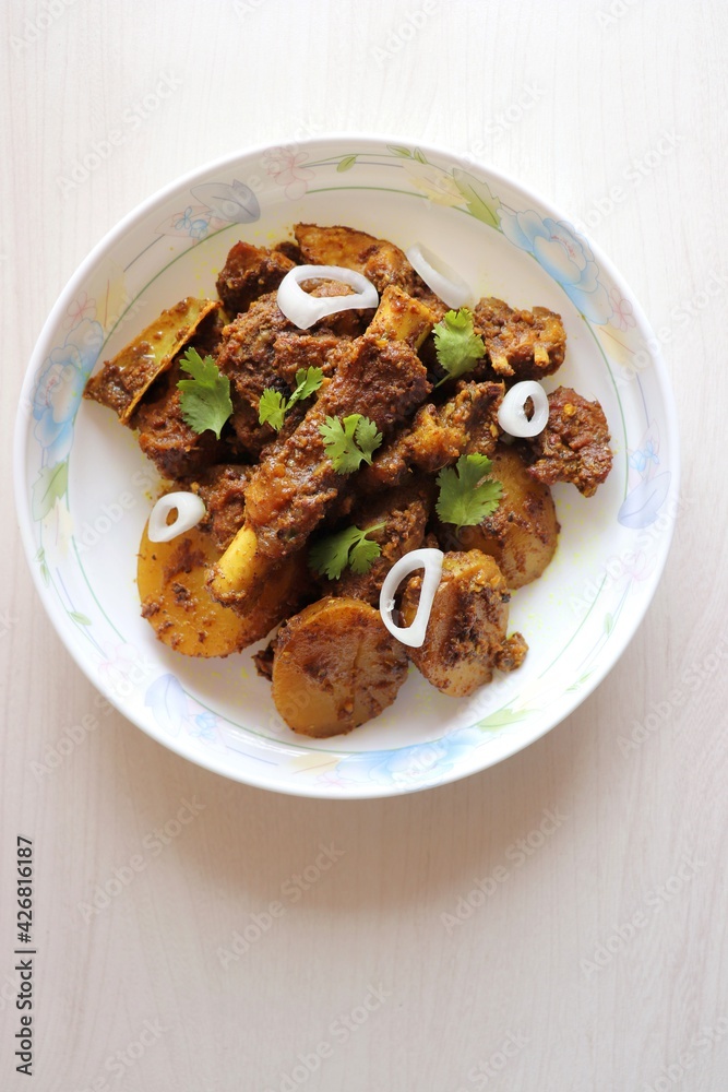 Mutton ghee roast. Goat meat fry with potatoes, also known as Mutton Batata bhujing. Spicy non-vegetarian lamb fry dish. Mutton curry or mutton fry. copy space.