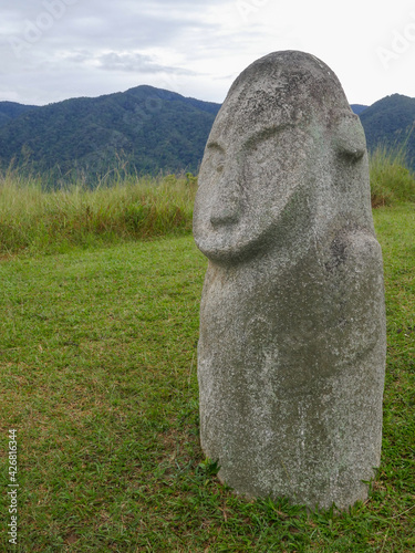 Side view of mysterious ancient megalith know as Loga in Lore Lindu National Park, Bada or Napu valley, Central Sulawesi, Indonesia