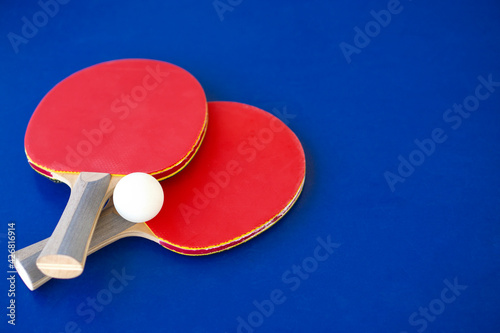 Two racket  for Table tennis  on blue background with copy space .