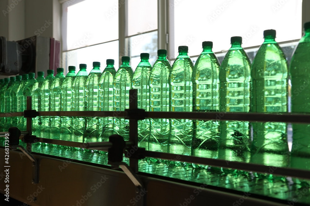 Conveyer line with plastic bottles filled with mineral water
