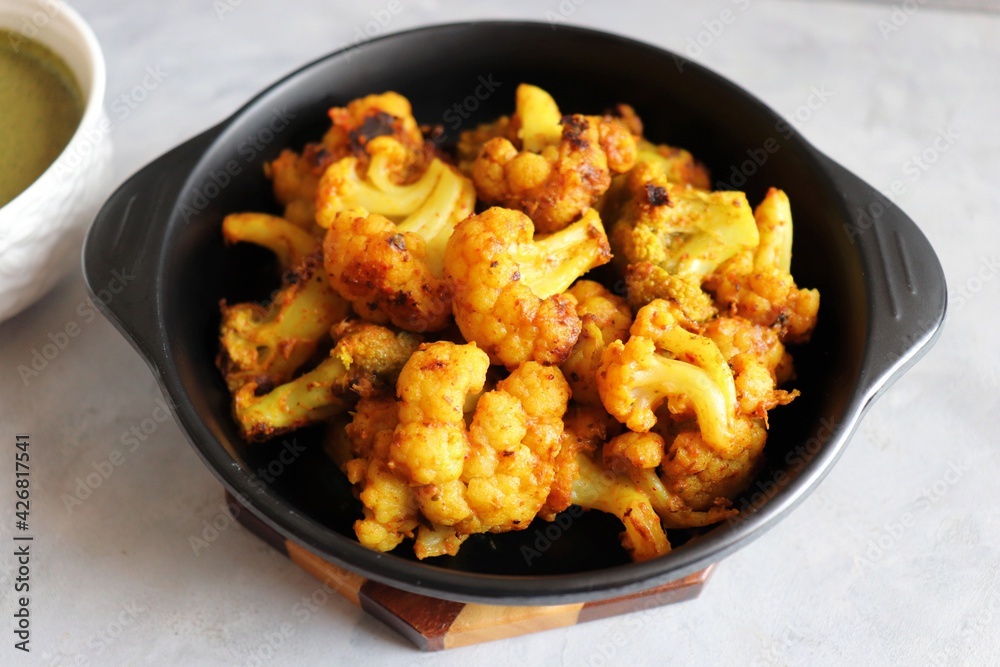 Gobi or Gobhi Tandoori. Masala Roasted cauliflower is a popular Indian vegetarian starter dish served with mint and coriander chutney. copy space. Gobi or Gobhi Tandoori. Masala Roasted cauliflower is a popular Indian vegetarian starter dish served with mint and coriander chutney. copy space.