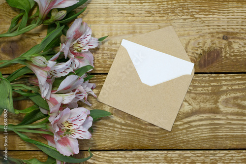 Simple small envelope with space for writing on wooden background with pen Narrow focus line, shallow depth of field