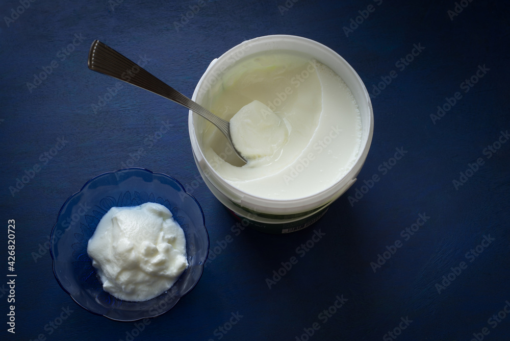 Creamy and nutritious yogurt is served in a bowl from the tub. Yoghurt