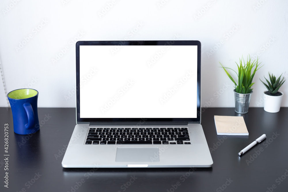 Fototapeta premium Front view. Laptop blank white screen on desk. Mockup.