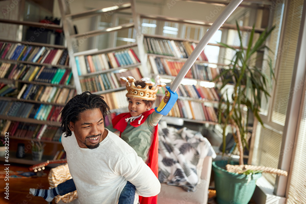 Afro american father and son playing together Afro american father and son playing together