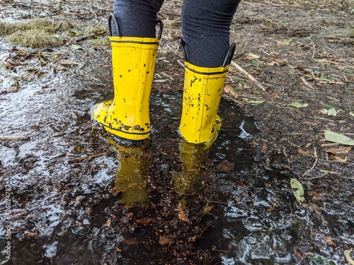 yellow rain boots in flooded marsh