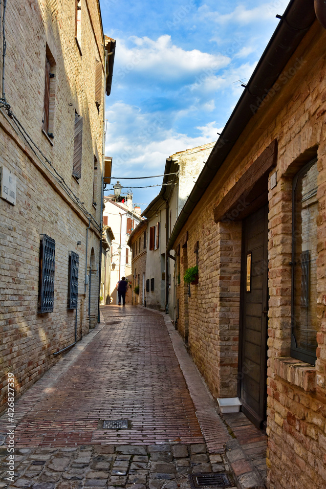 A narrow street between the old houses of Civitanova Alta, a medieval town in the Marche region of Italy.