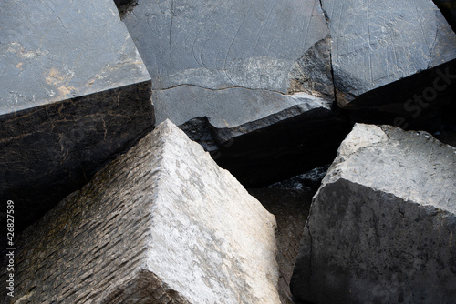 pile of breakwater stones on the coast