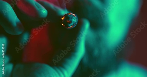 A man smokes a cigar in slow motion and exhales the smoke in close-up. Video about bad habits. photo