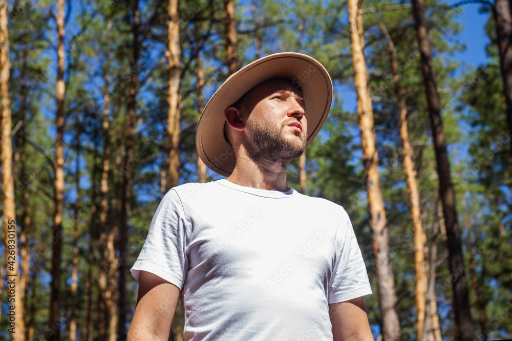 Man with a hat in the forest. Hike in the mountains, forest Man with a hat in the forest. Hike in the mountains, forest