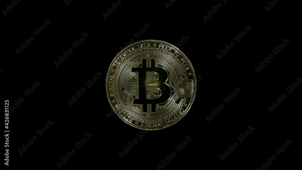 Golden color, metallic Bitcoin coin is glitters in the rays of light. Hodl, Hodler - Internet meme, slang name for those who buy cryptocurrencies and hold them. Macro. Closeup