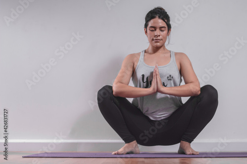 Young woman practicing yoga in studio © Socrates