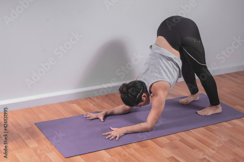 Young woman practicing yoga in studio
