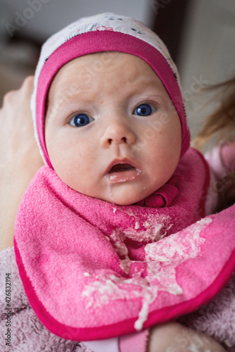 Little Baby regurgitated with breast milk. Care for children. Baby Feeding Concept