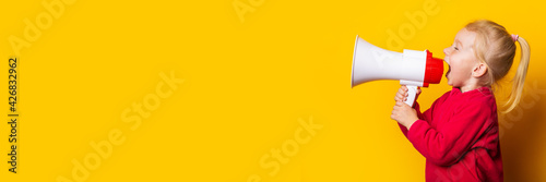 child shouts into a white megaphone on a bright yellow background. Banner photo