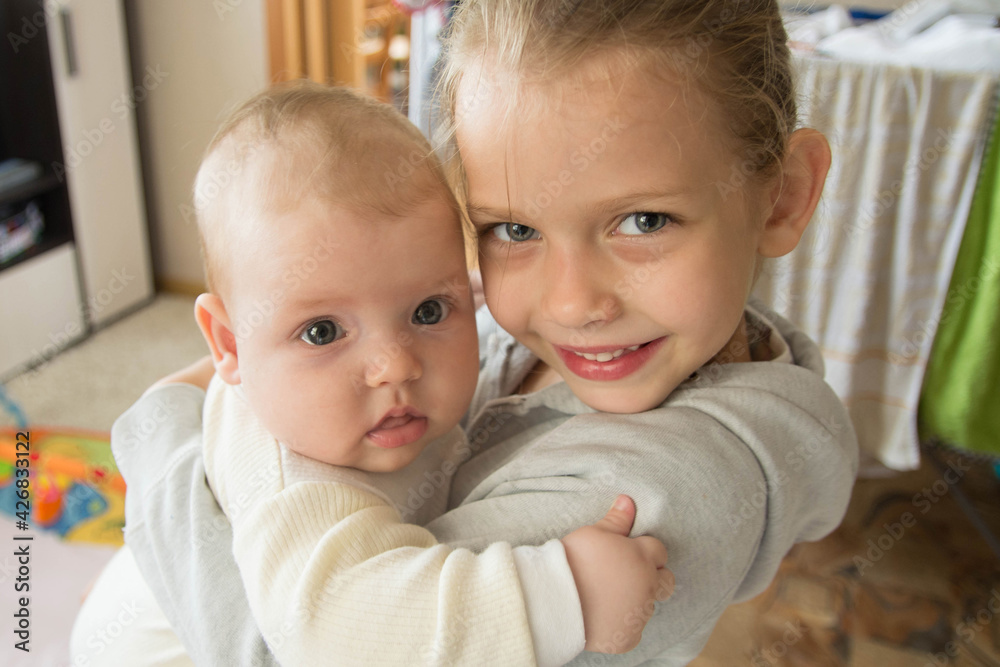 Two sisters look at the photo directly into the camera. Two sisters look at the photo directly into the camera.