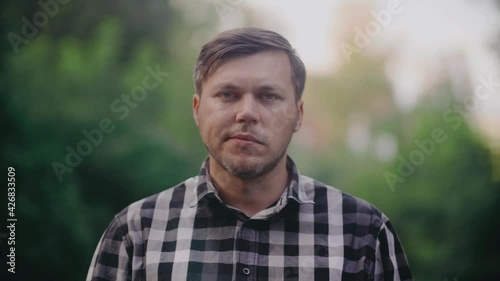 Unshaven man chewing gum.Unshaven man chewing gum. Checkered shirt.