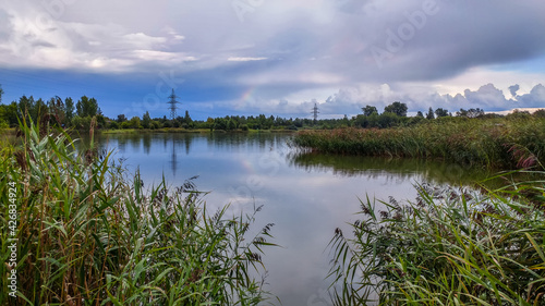 Obraz na płótnie Landscape with a view of the lake and a beautiful sky with clouds above it w salonie