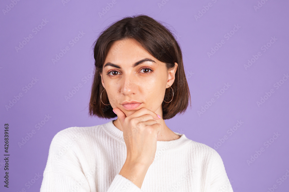 Young brunette in white casual sweater isolated on purple background thinking worried about a question, concerned and nervous Young brunette in white casual sweater isolated on purple background thinking worried about a question, concerned and nervous