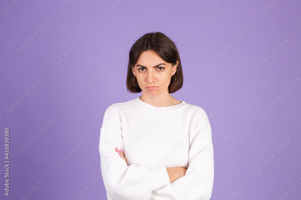 Young brunette in white casual sweater isolated on purple background with gloomy expression needs support and help Young brunette in white casual sweater isolated on purple background with gloomy expression needs support and help