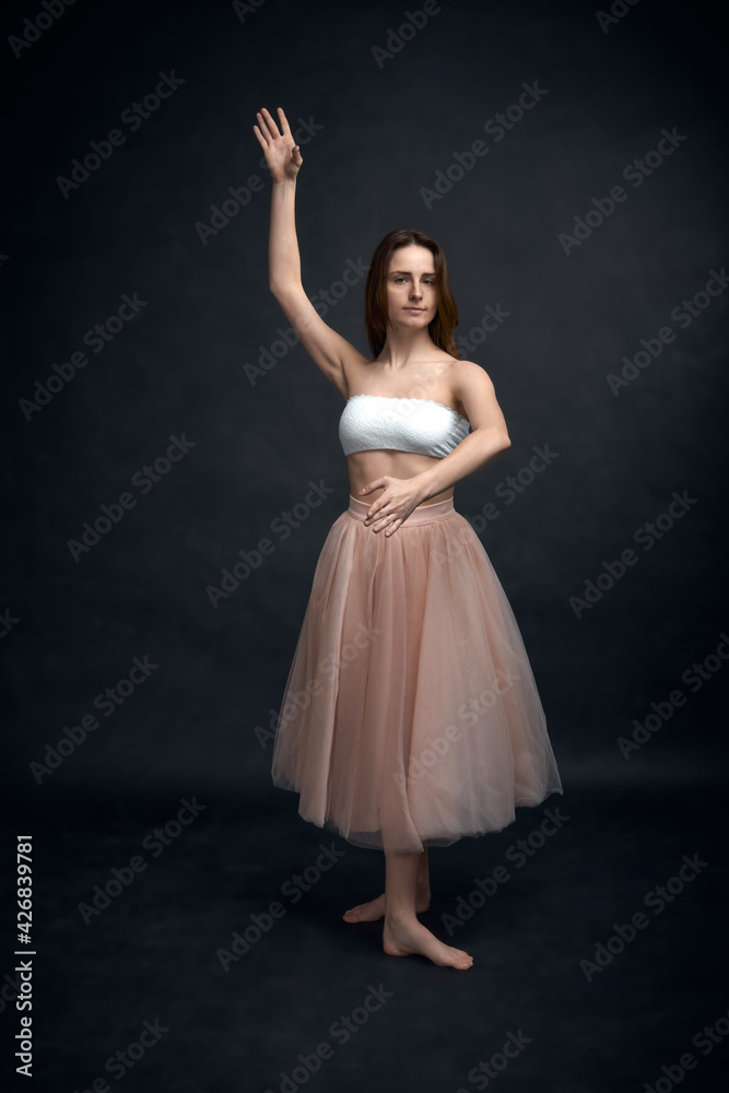 Young girl in white top and peach skirt dancing Young girl in white top and peach skirt dancing