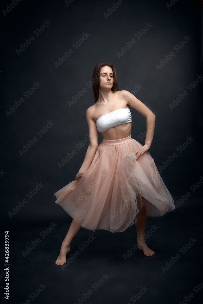 Young girl in white top and peach skirt dancing Young girl in white top and peach skirt dancing